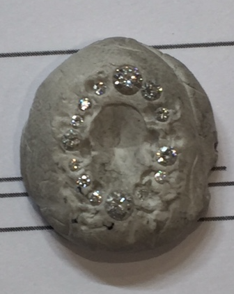 We help this process along by sending all of our notes and designs through to our designer, and on this occasion we trialled stone size and placement of our halo ring. White tac suddenly becomes invaluable to us.