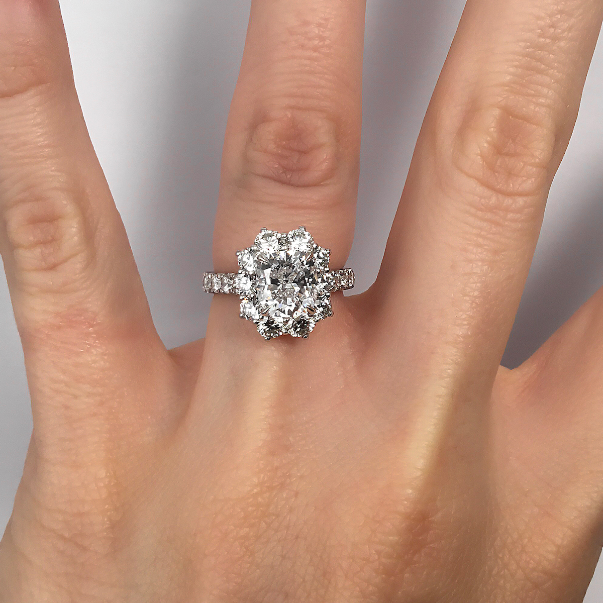 cluster halo diamond engagement ring diamond set finger.jpg